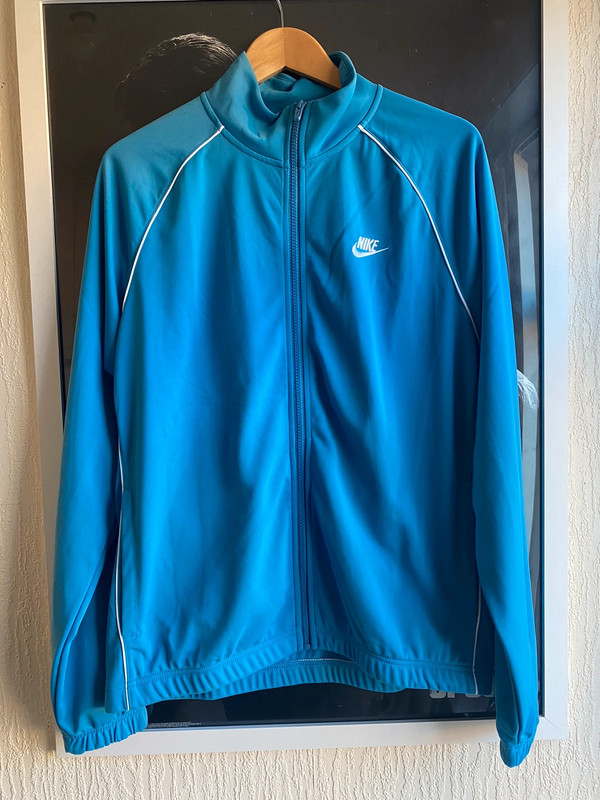 Blue nike track top shop