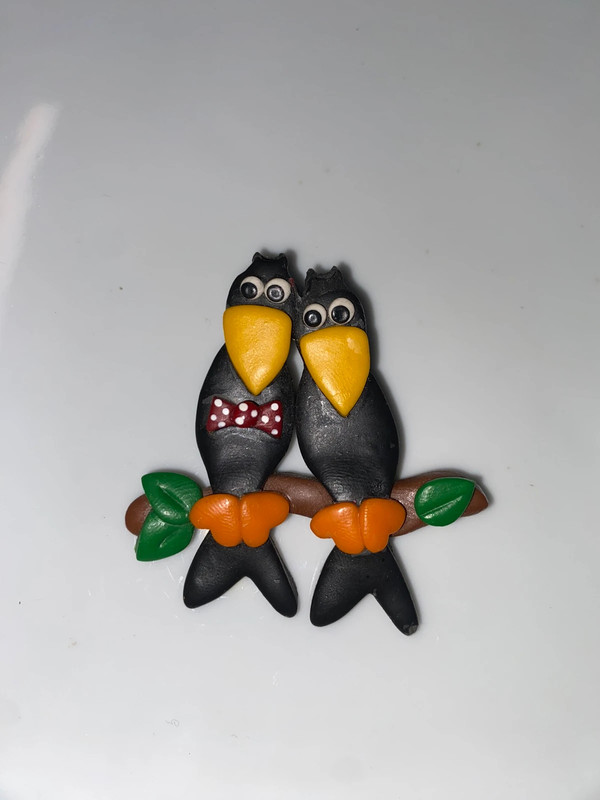 Vintage black plastic brooch double birds double toucans on perch black yellow orange 1