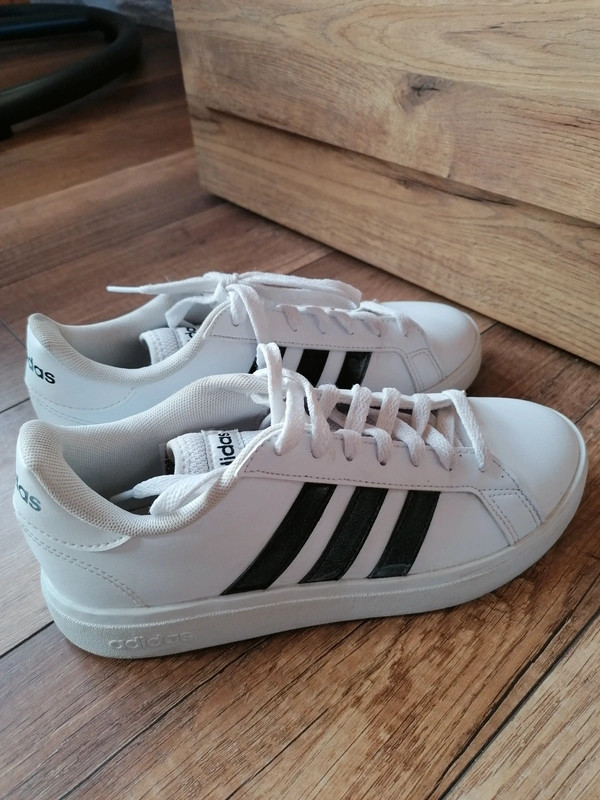 Adidas white shoes with online black stripes on one side