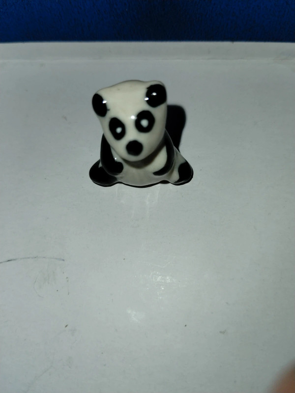 Very adorable small miniature black and white panda bear display