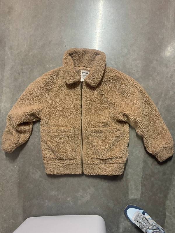 Teddy bear jacket’s brand is garage. 1
