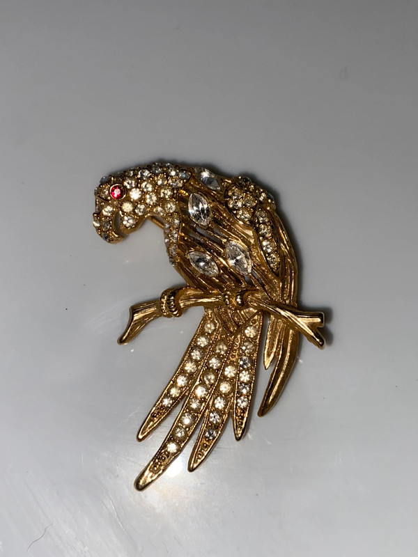 Vintage goldtone metal bird brooch on perch clear snd red faceted stones 1