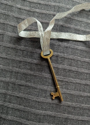 Plastic gold key on silver ribbon, brand: Silver, condition: Good, £1.00, £1.75 includes Buyer Protection